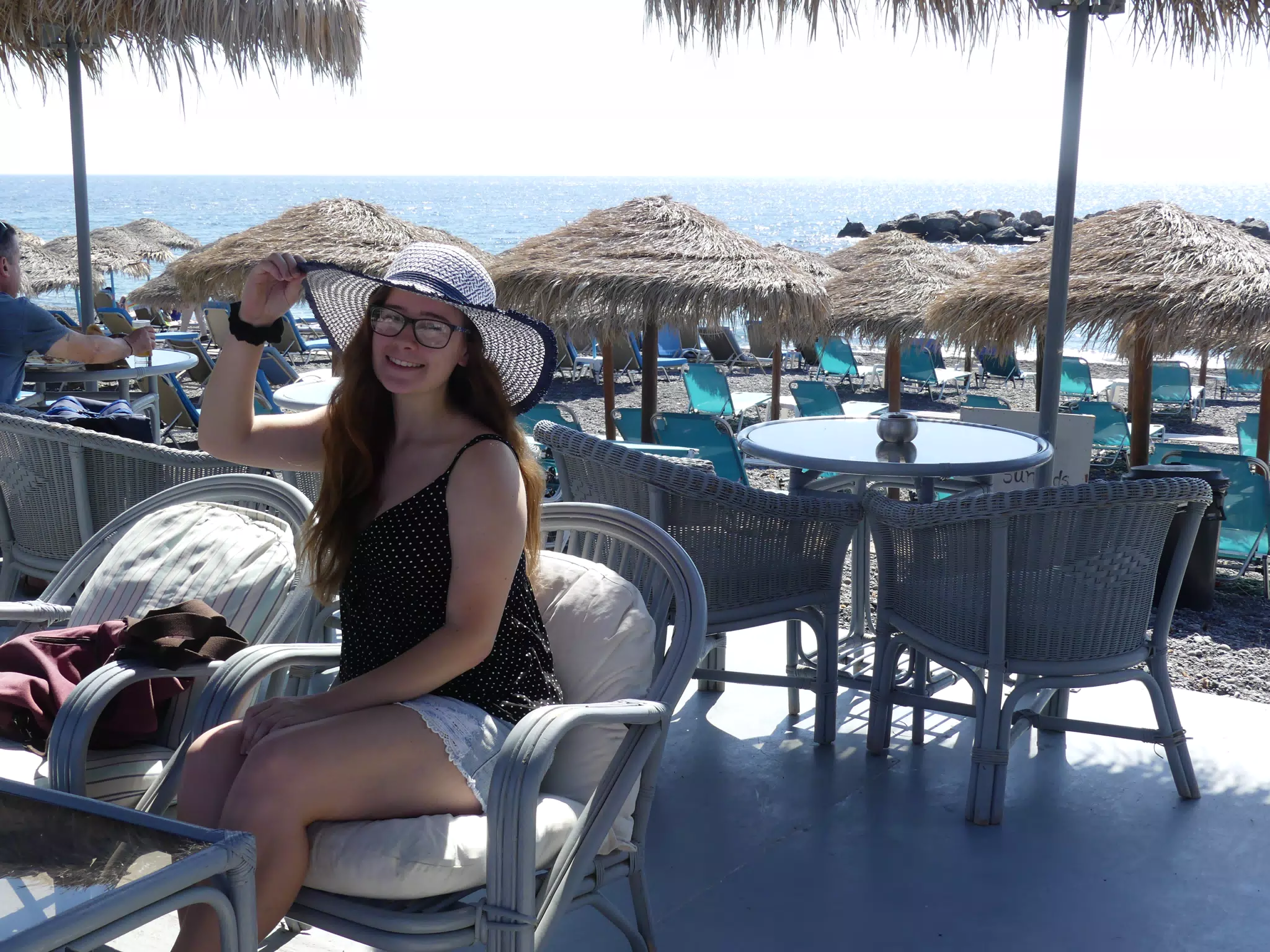 Girl in Hat and Skirt on Santorini Beach in Kamari
