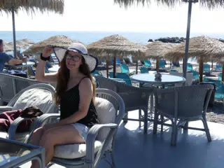 Girl in Hat and Skirt on Santorini Beach in Kamari