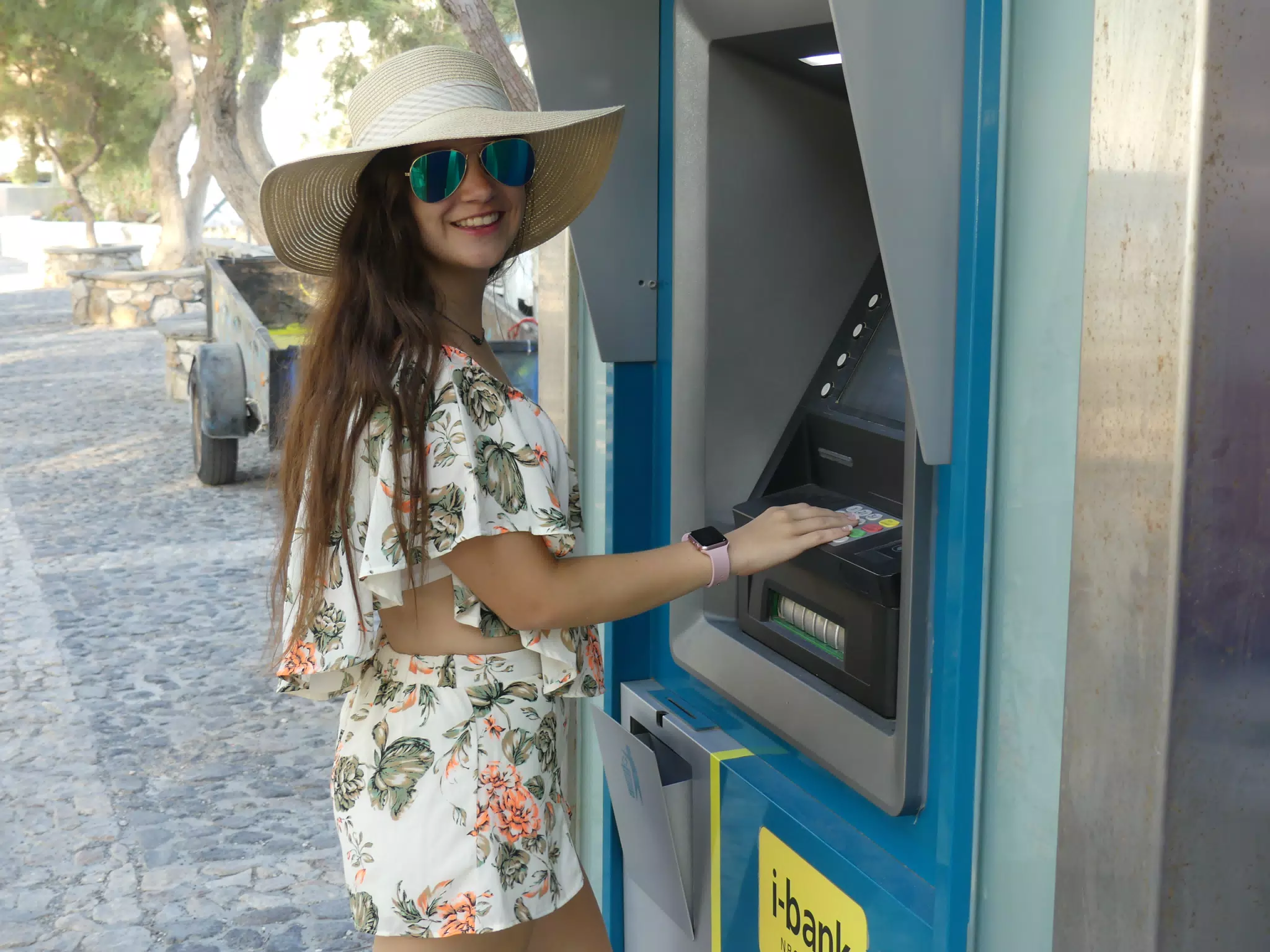 Teen Girl Using ATM on Santorini