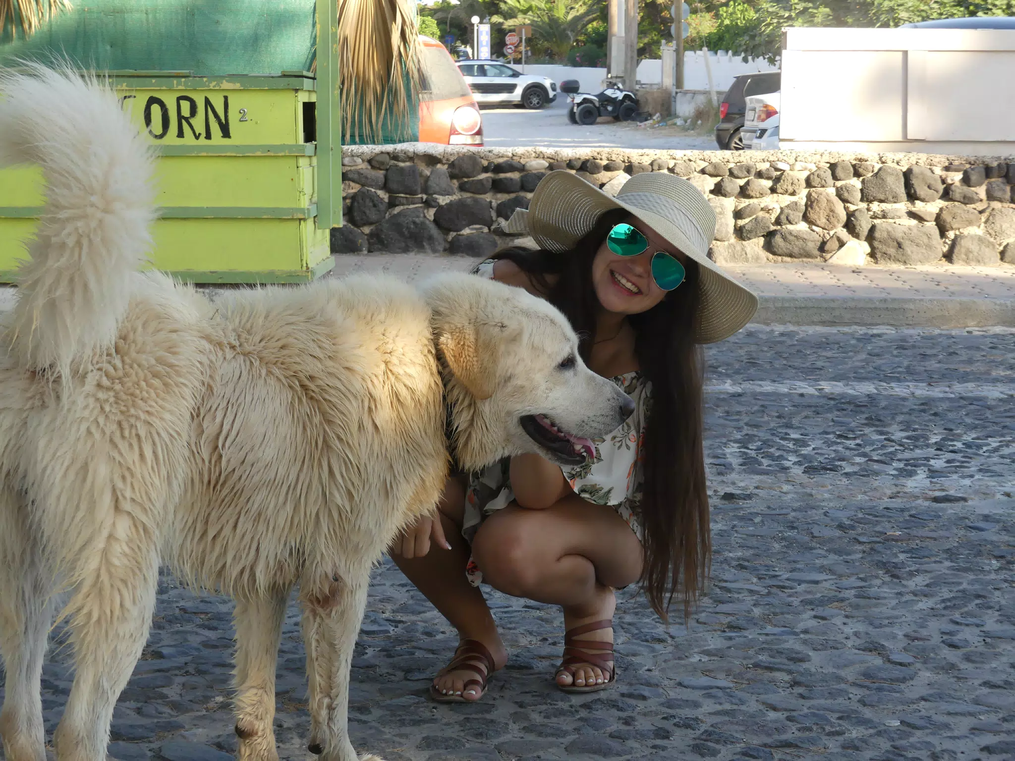Emily on Street with Dog in Kamari