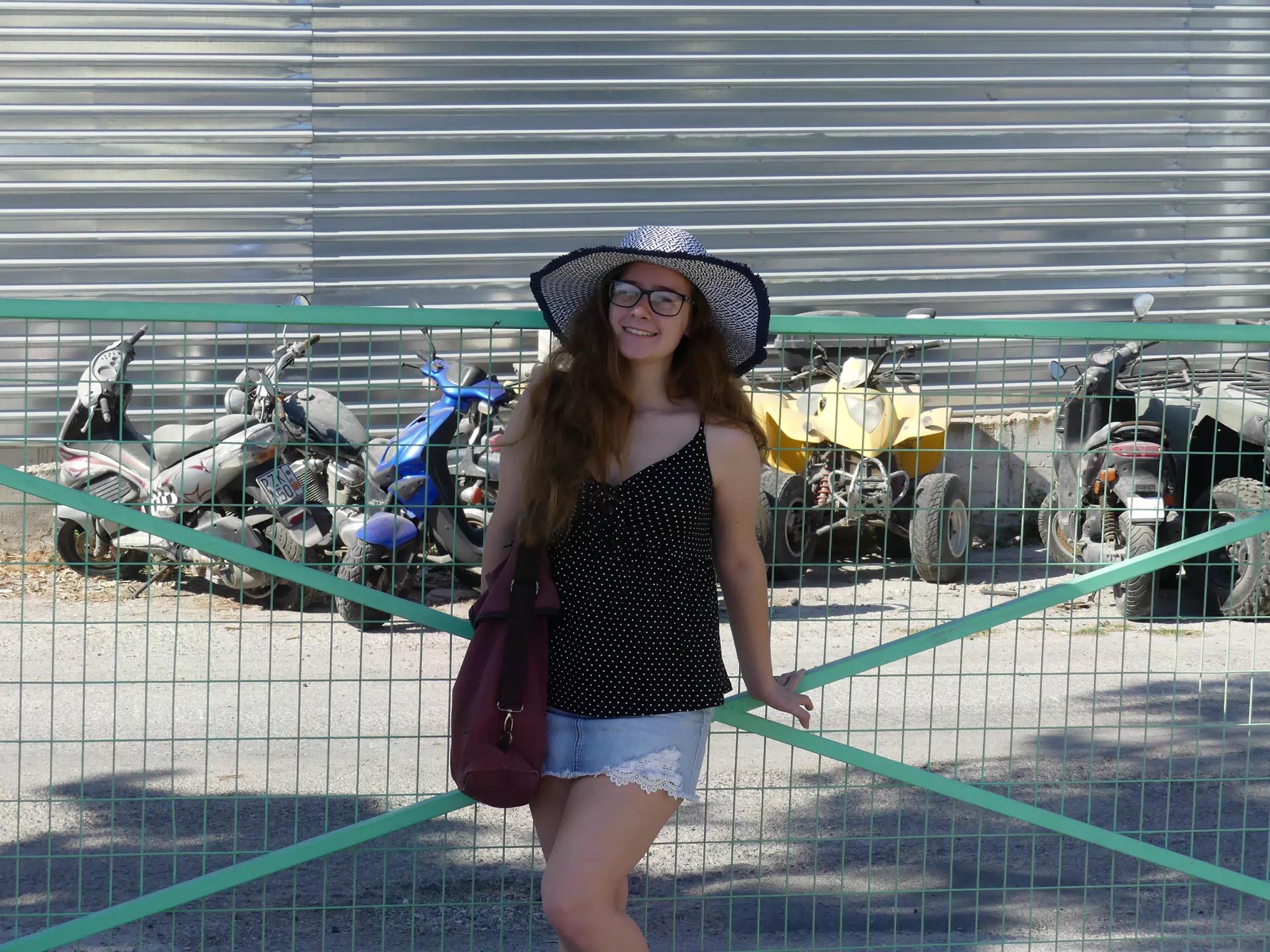 Girl in Hat by Motorsports Rental in Santorini
