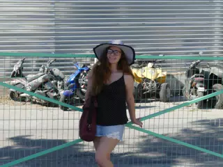 Girl in Hat by Motorsports Rental in Santorini