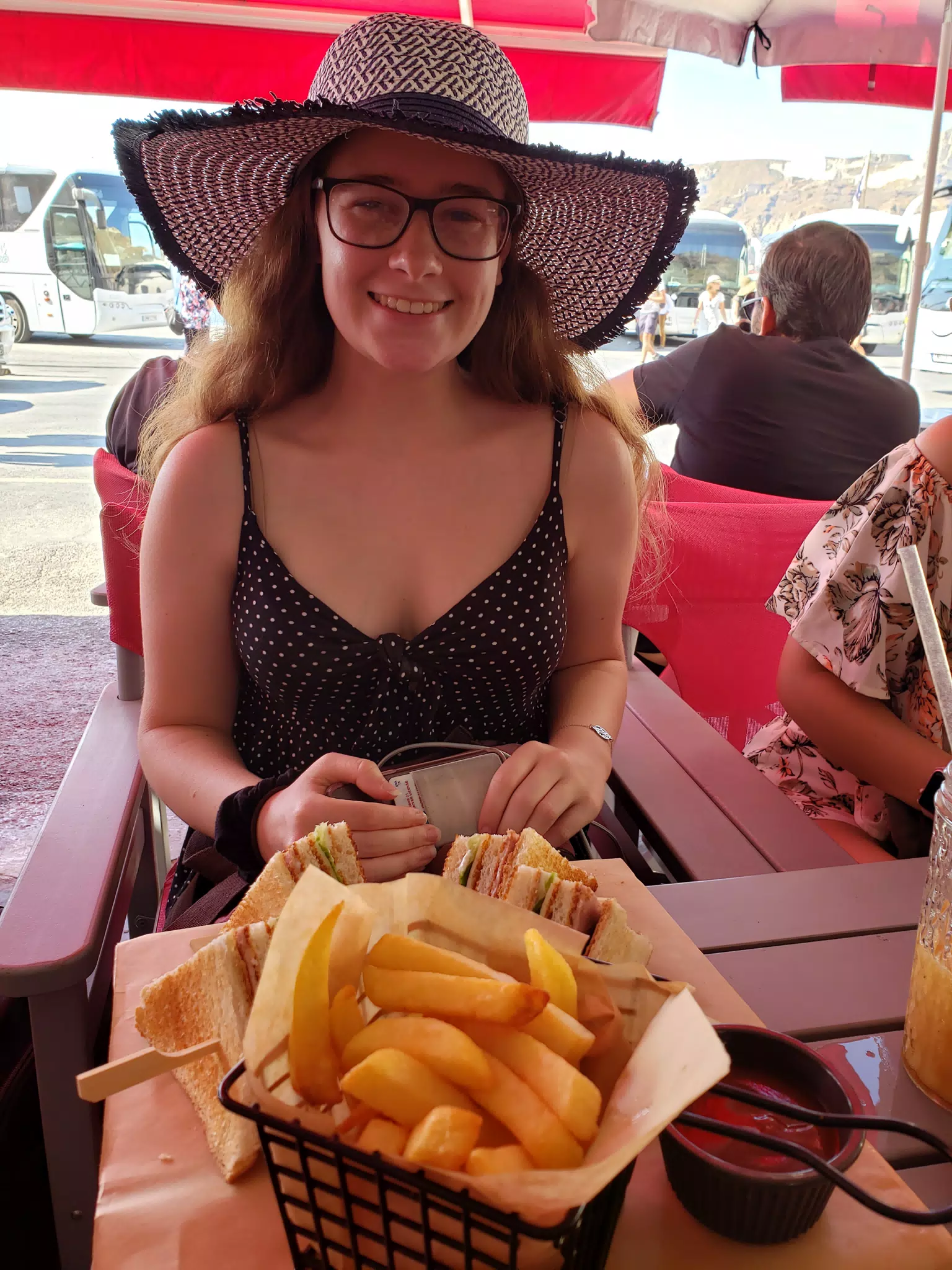 Madeline with Fries and Sandwich by the Sea on Santorini
