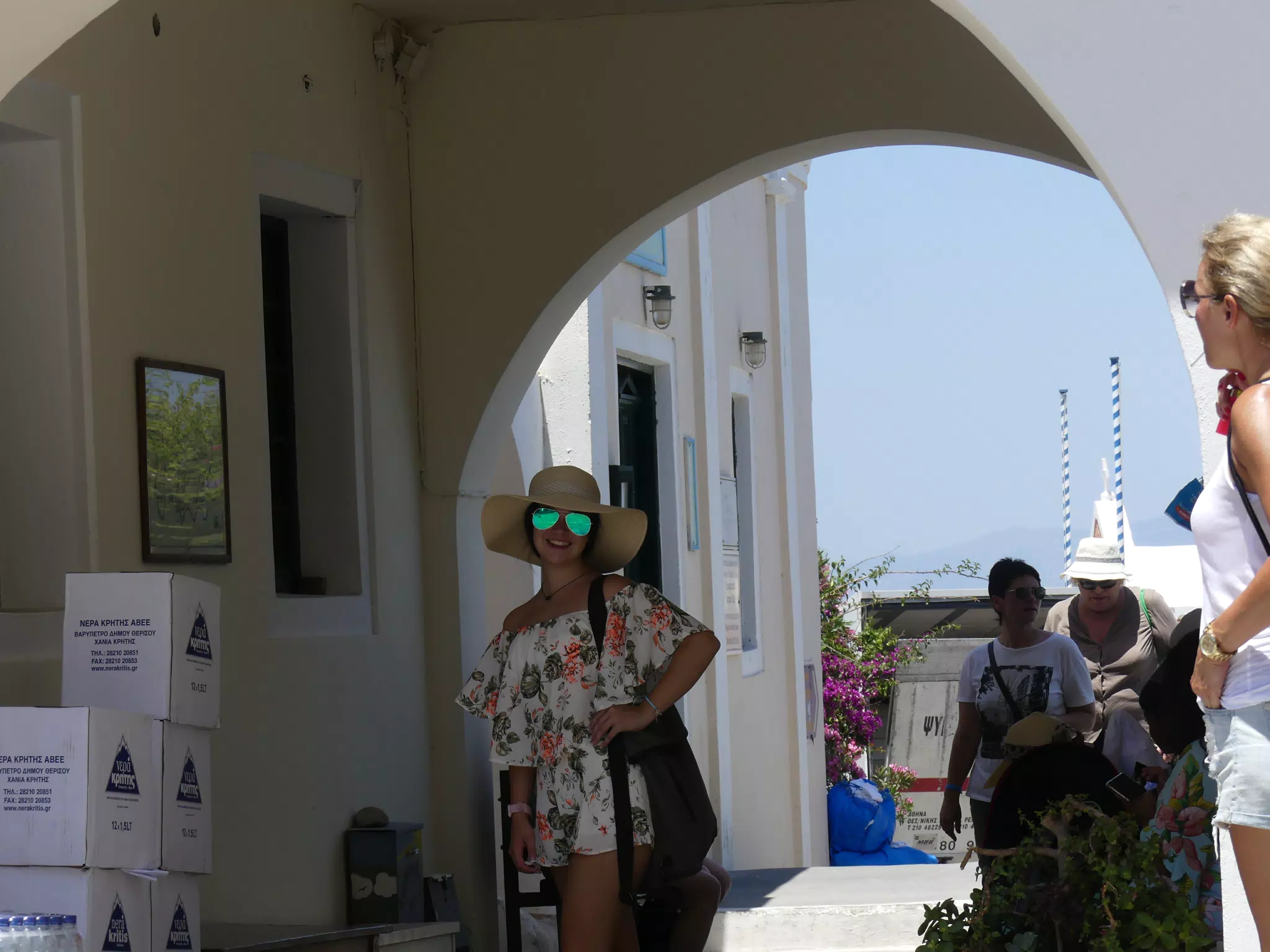 Emily in Hat and Sunglasses in Oia, Santorini