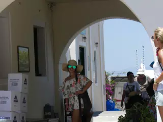 Emily in Hat and Sunglasses in Oia, Santorini