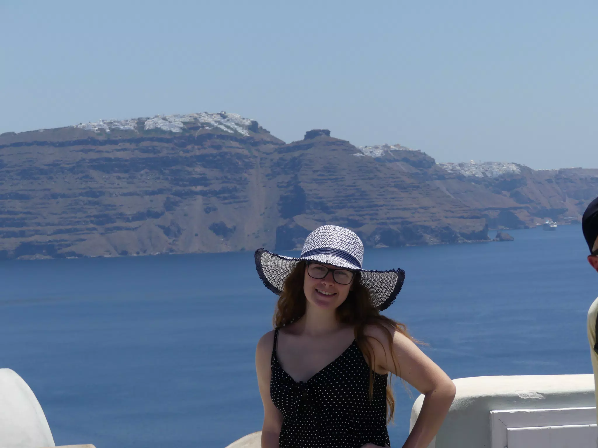 Madeline in Hat in Oia, Santorini in Front of the Sea