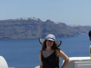 Madeline in Hat in Oia, Santorini in Front of the Sea