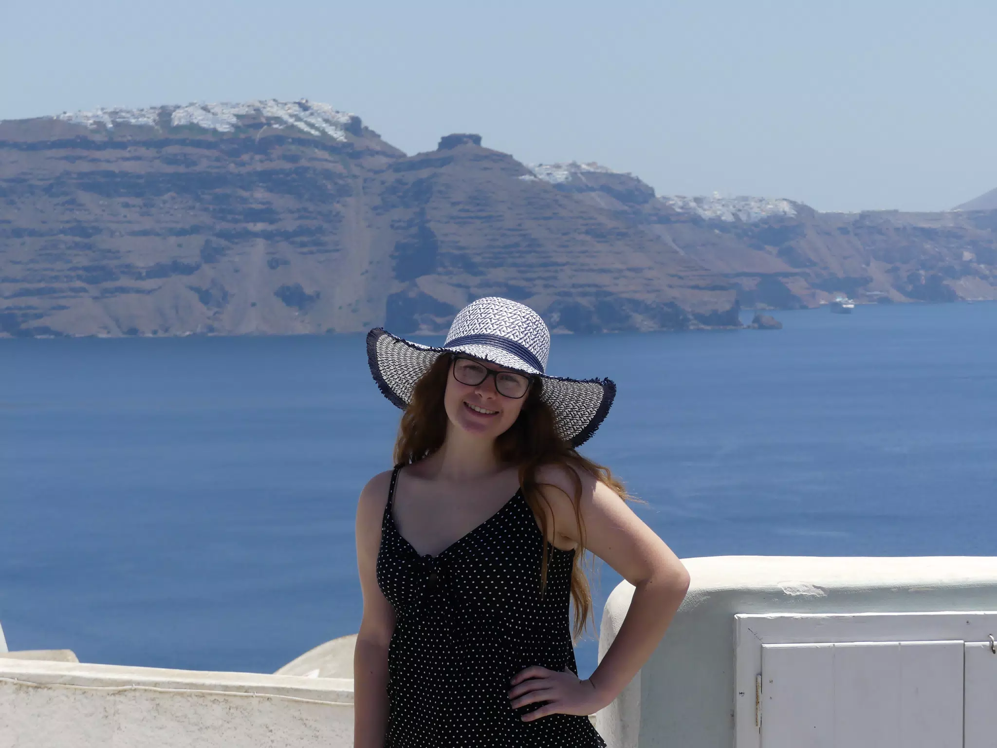 Madeline in Hat in Oia, Santorini in Front of the Sea
