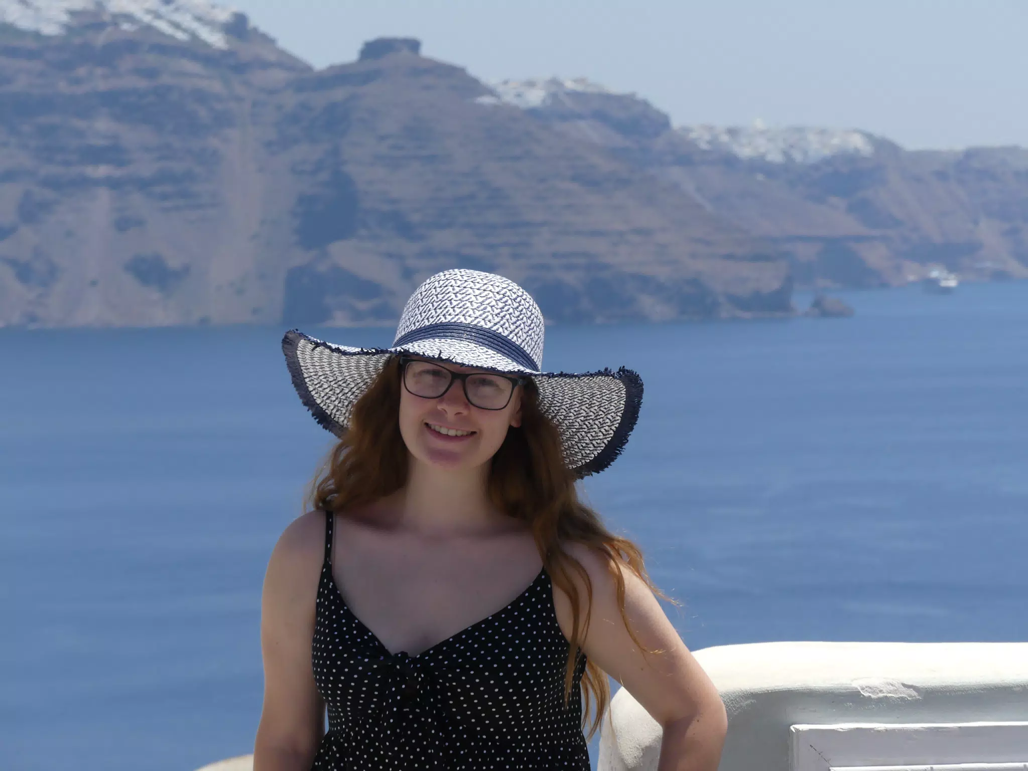 Madeline in Hat in Oia, Santorini in Front of the Sea