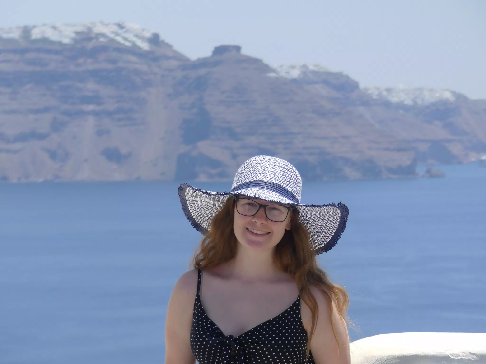 Madeline in Hat in Oia, Santorini in Front of the Sea