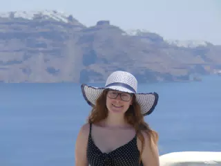 Madeline in Hat in Oia, Santorini in Front of the Sea