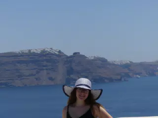 Madeline in Hat in Oia, Santorini in Front of the Sea