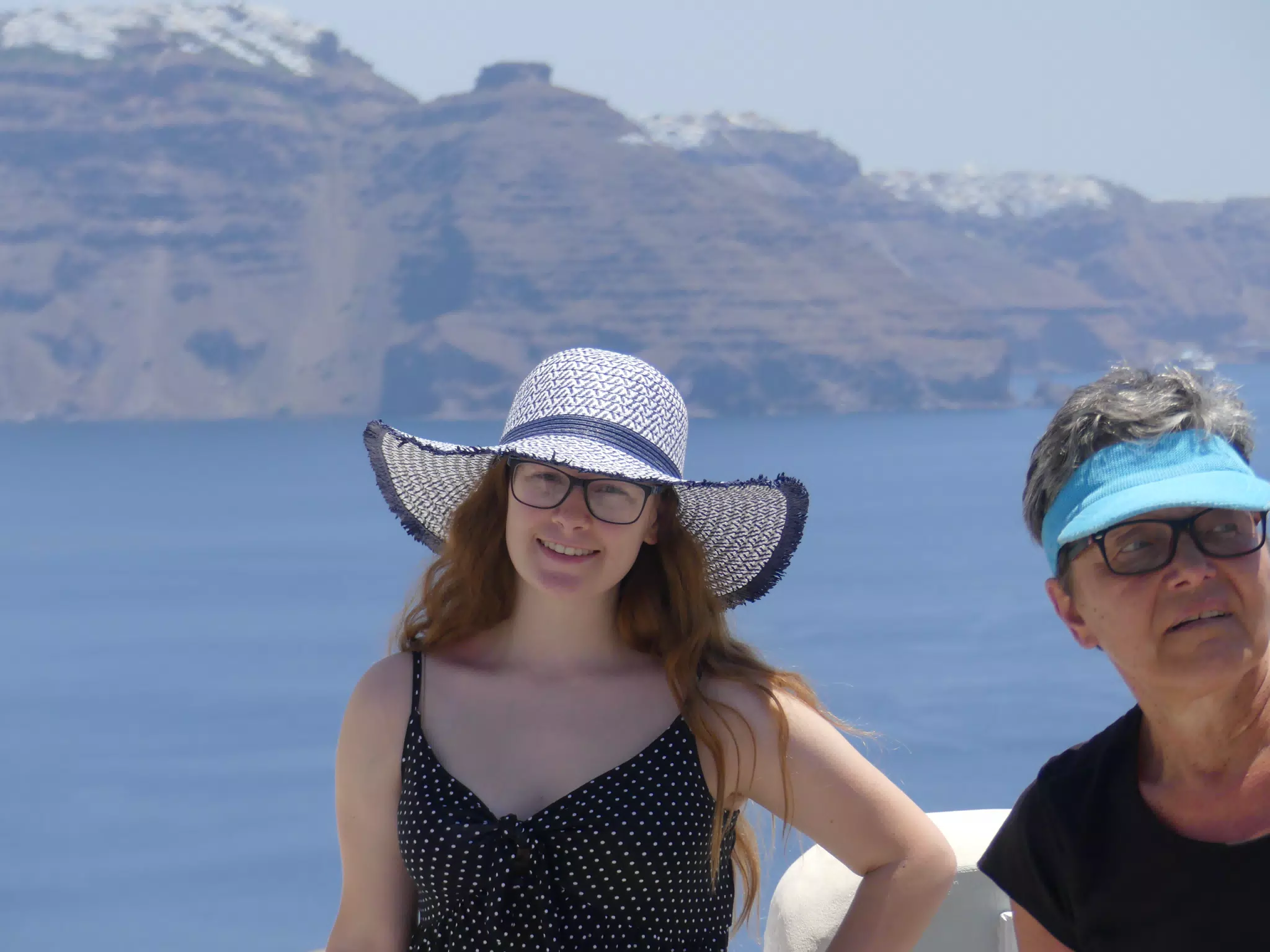 Madeline in Hat in Oia, Santorini in Front of the Sea
