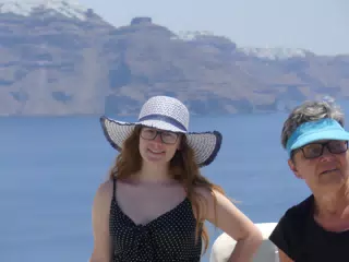 Madeline in Hat in Oia, Santorini in Front of the Sea