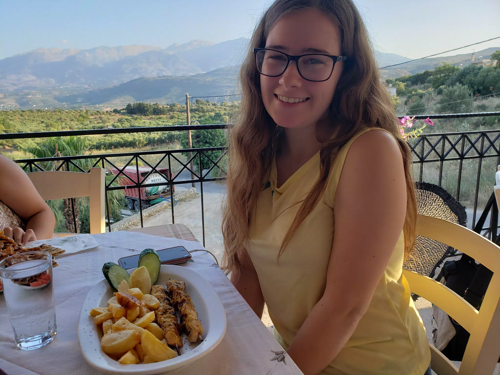 Madeline Eating at the Cretan Corner in Aptera
