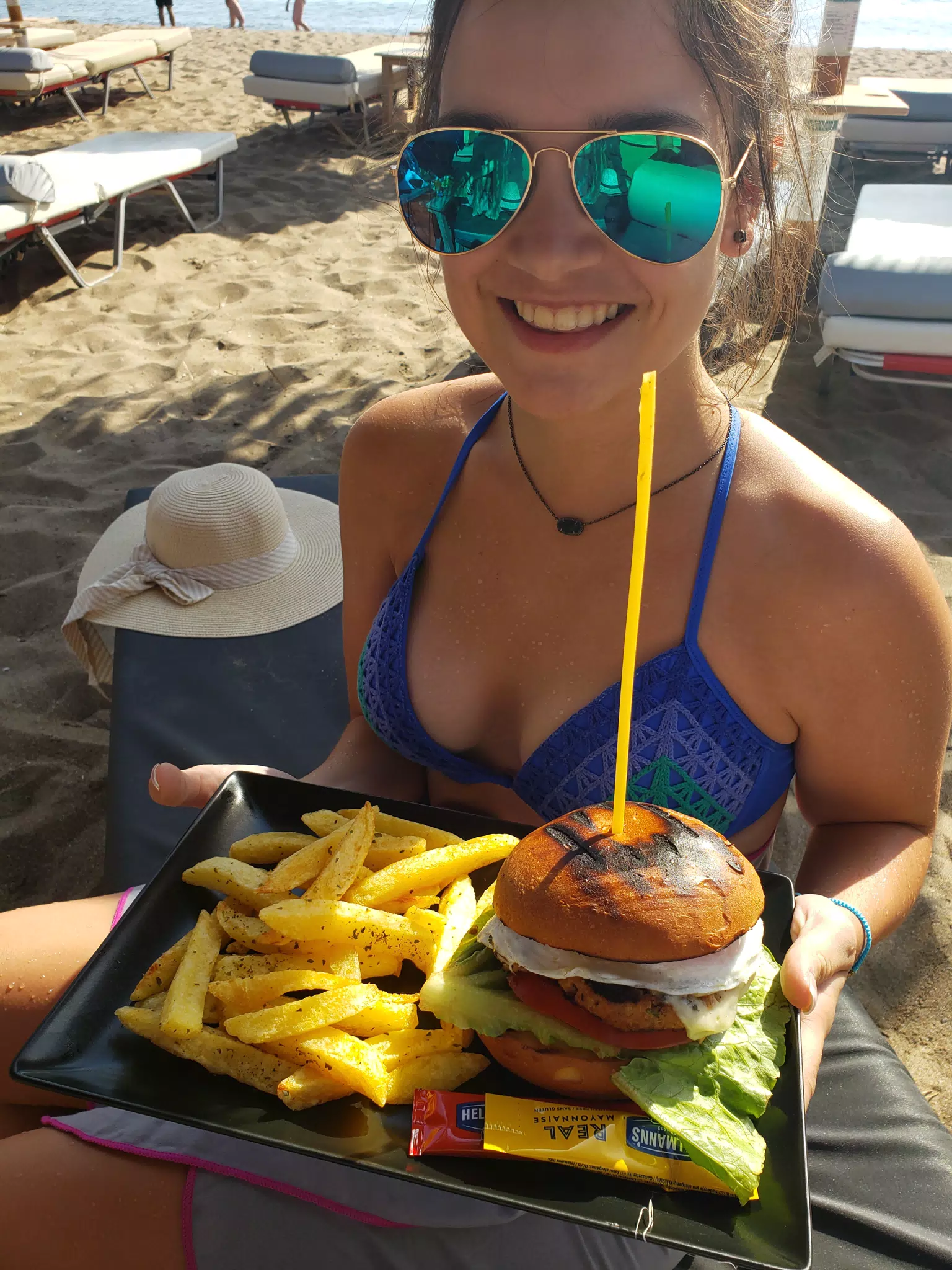 Emily with Burger on the Beach at Paleochora, Crete, Greece