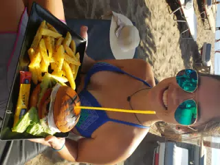 Emily with Burger on the Beach at Paleochora, Crete, Greece