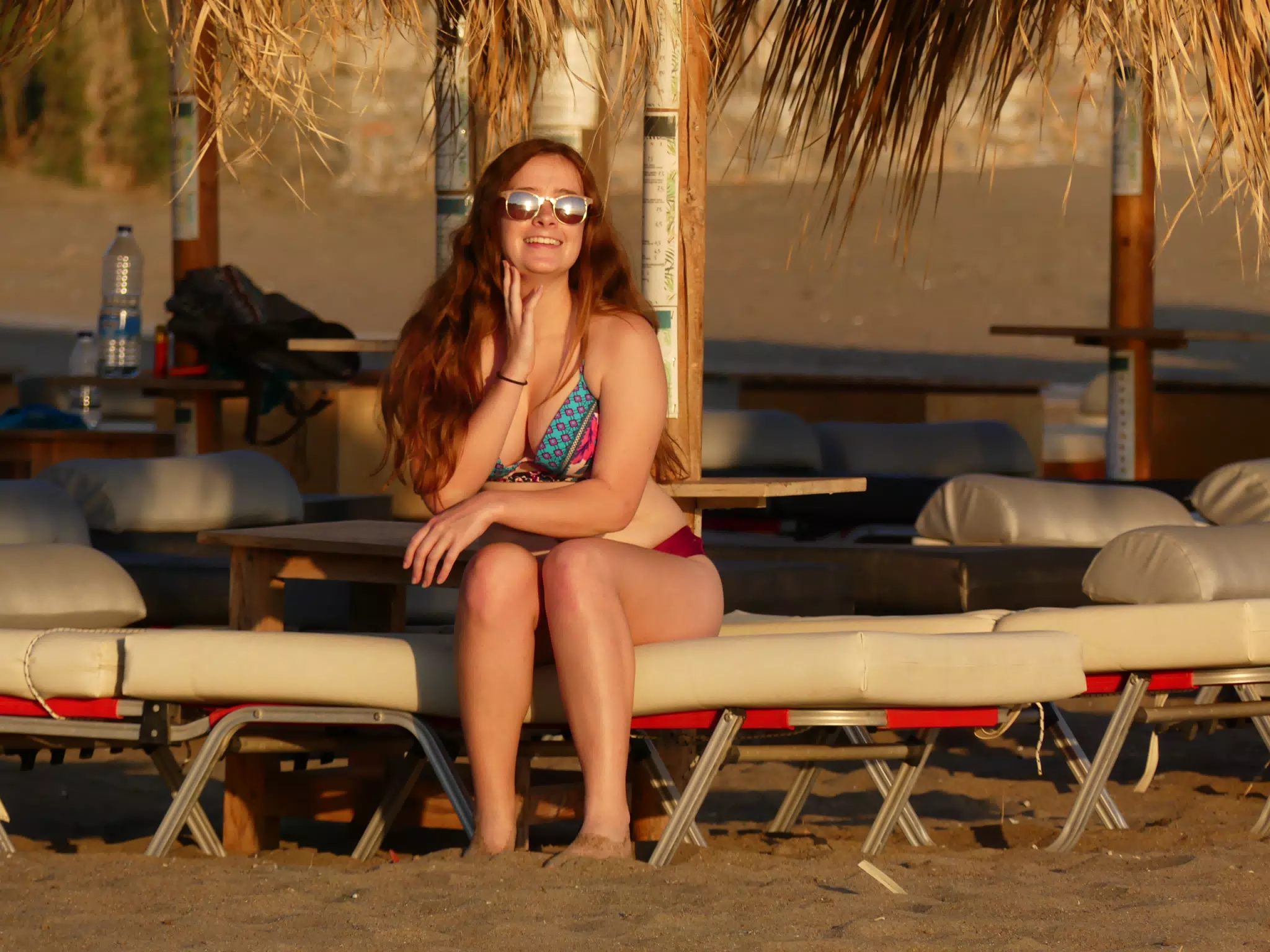 Teen Posing on Beach Chair on Palaiochora Beach, Crete, Greece in Sunset