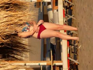 Girl behind beach umbrella