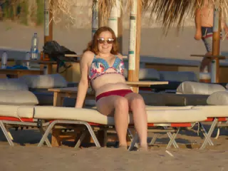 Madeline Relaxing at Sunset on Beach Chair on Greek Beach at Palaiochora