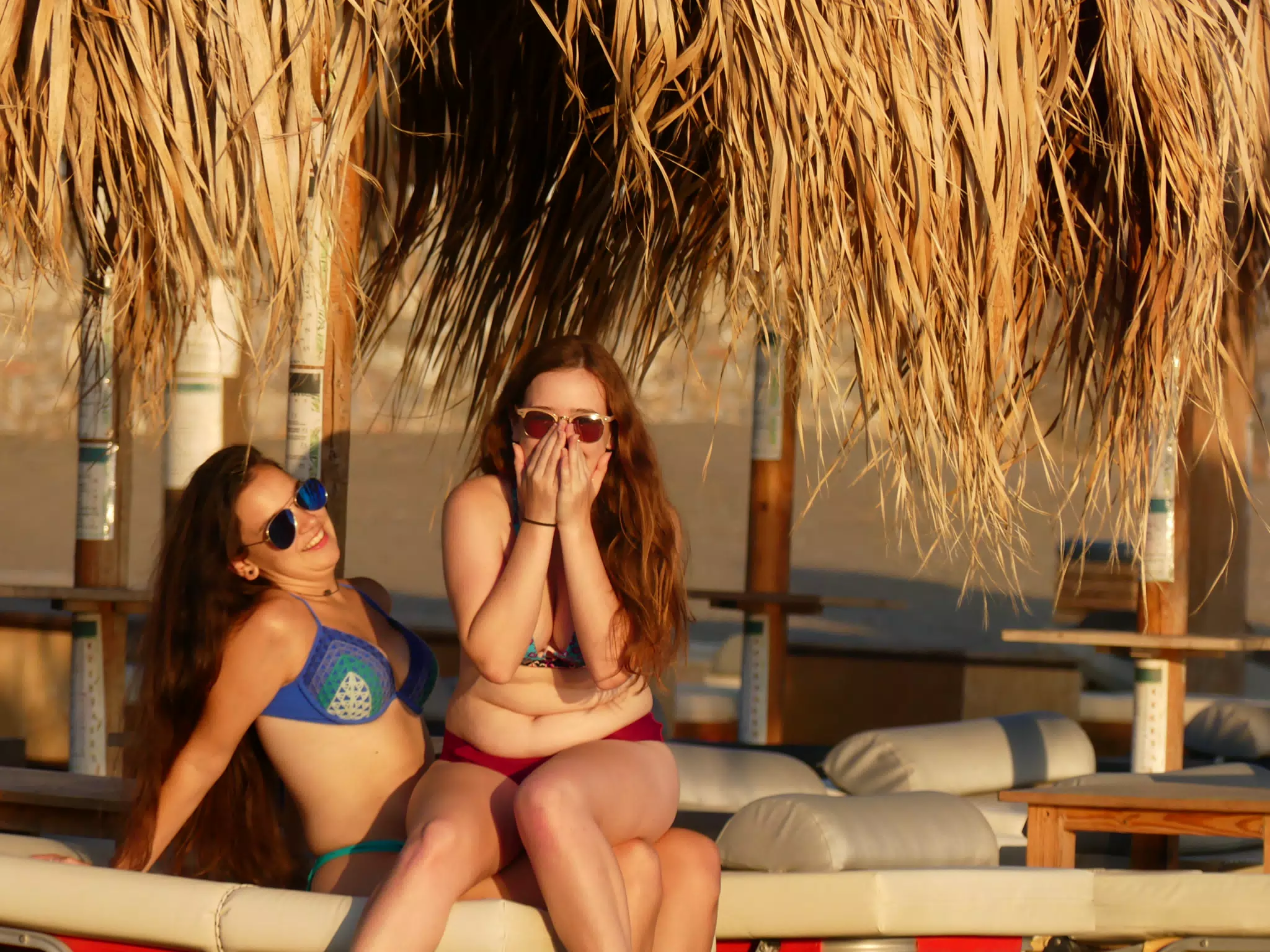 Teen Girls Sitting on Lap on Palaiochora Beach on Crete