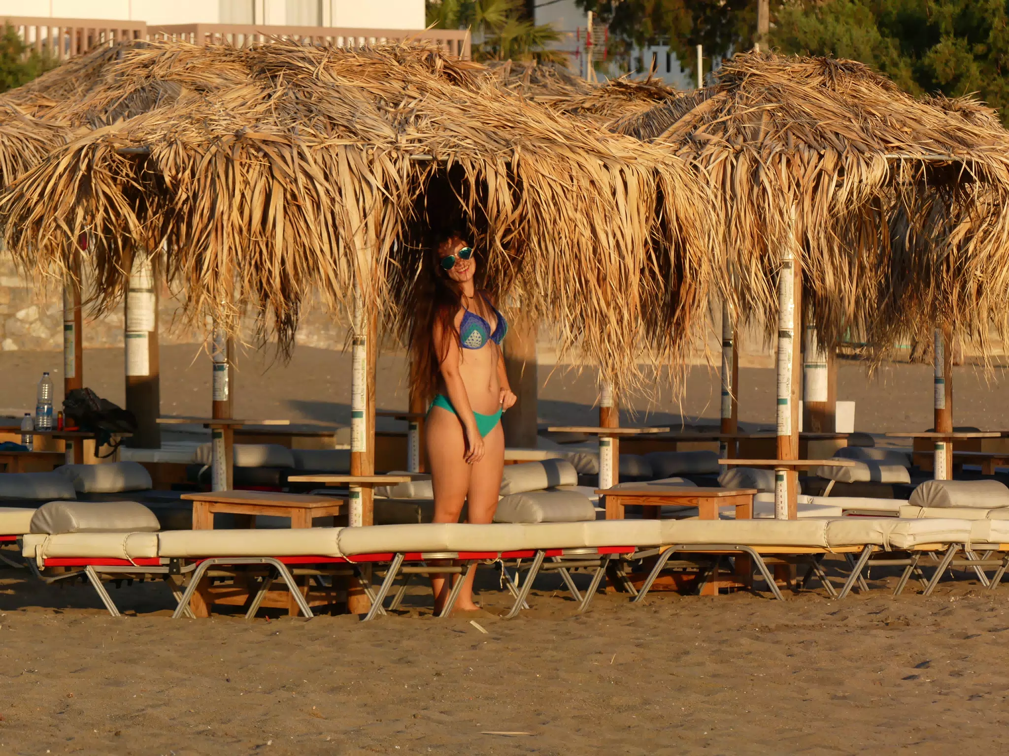 Emily on Beach in Swimsuit Under Umbrellas