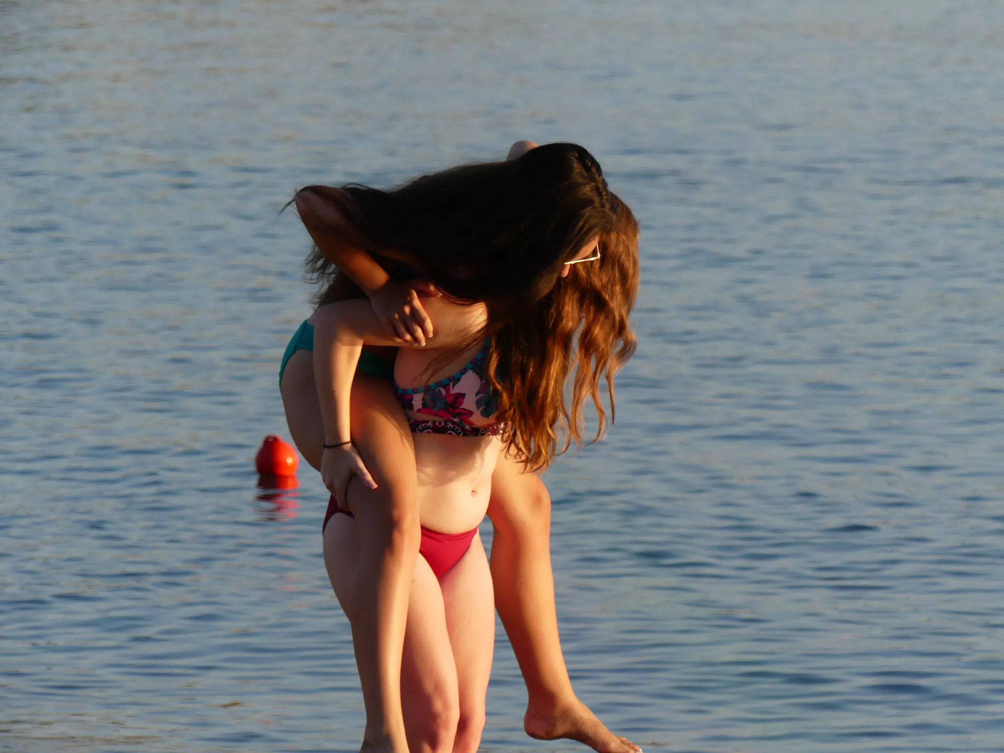 Emily Trying to Ride Madeline on the Beach