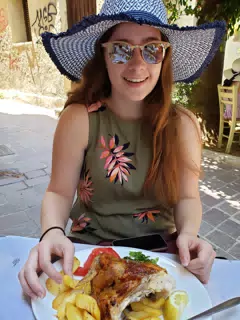 Madeline Eating Grilled Chicken in Chania