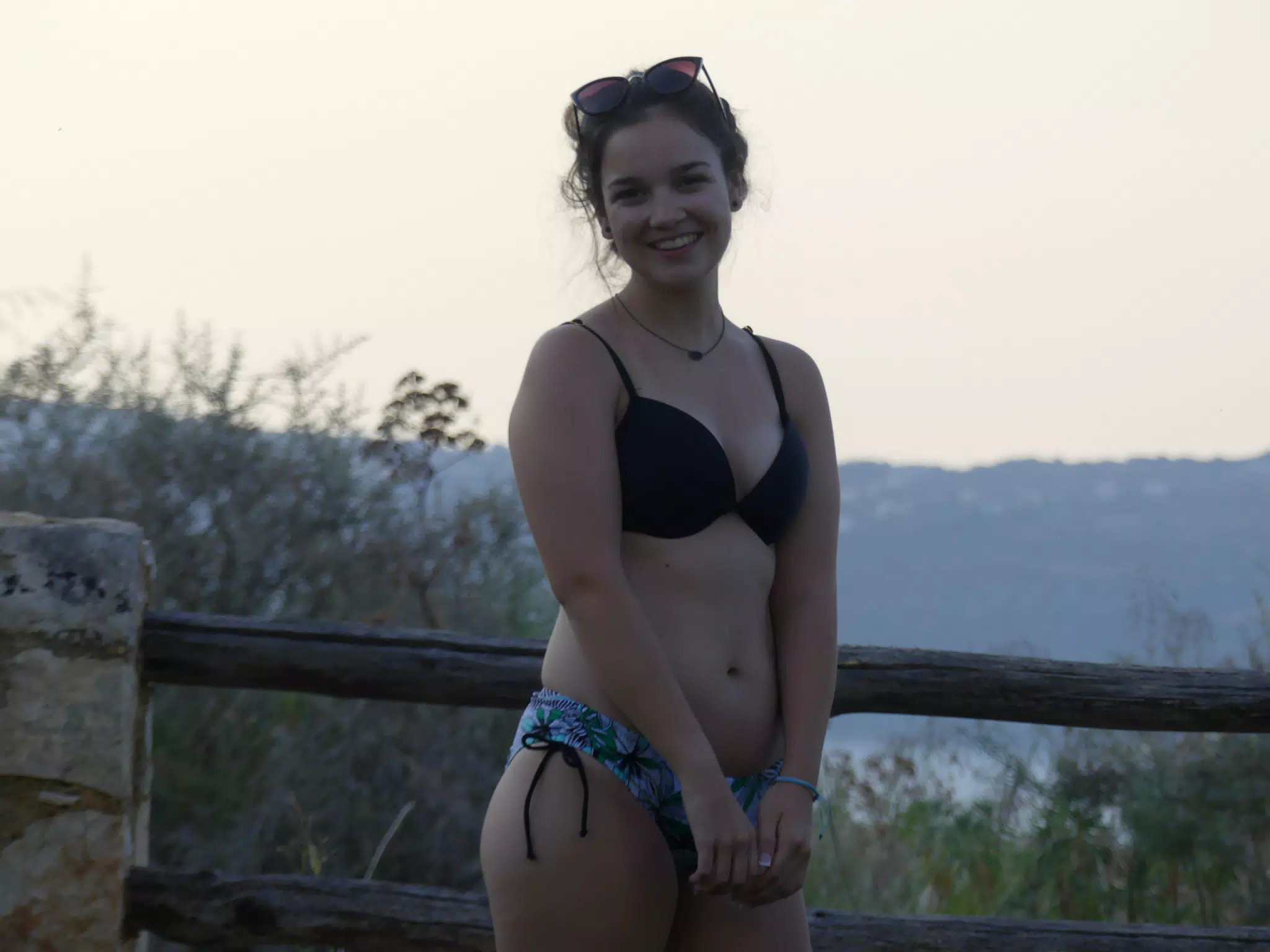 Girl Posing by Fence at Twilight