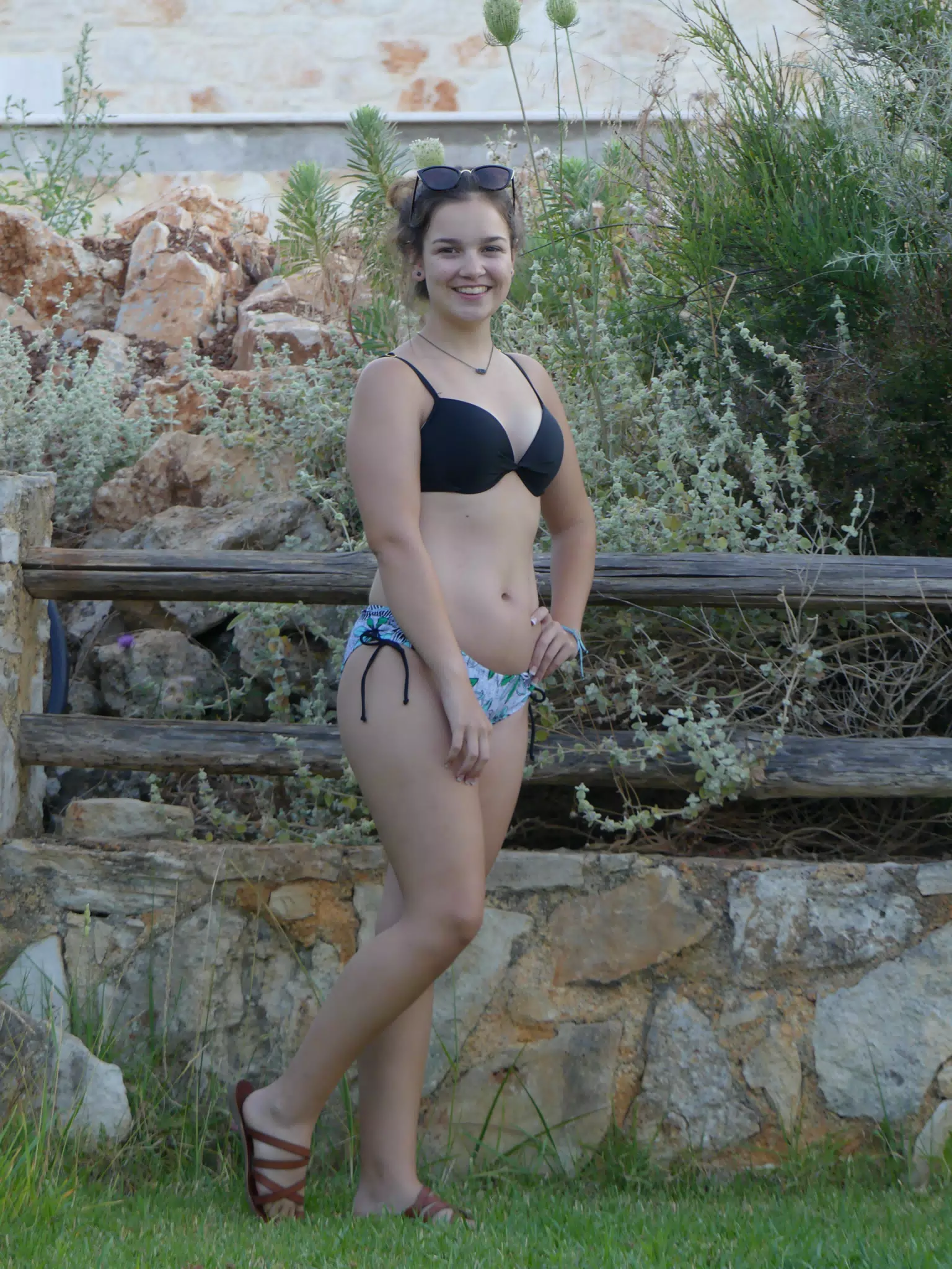 Emily Posing by the Fence at Aptera Apartment