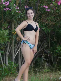 Brunette Standing in Bikini by Flowers in Aptera, Crete