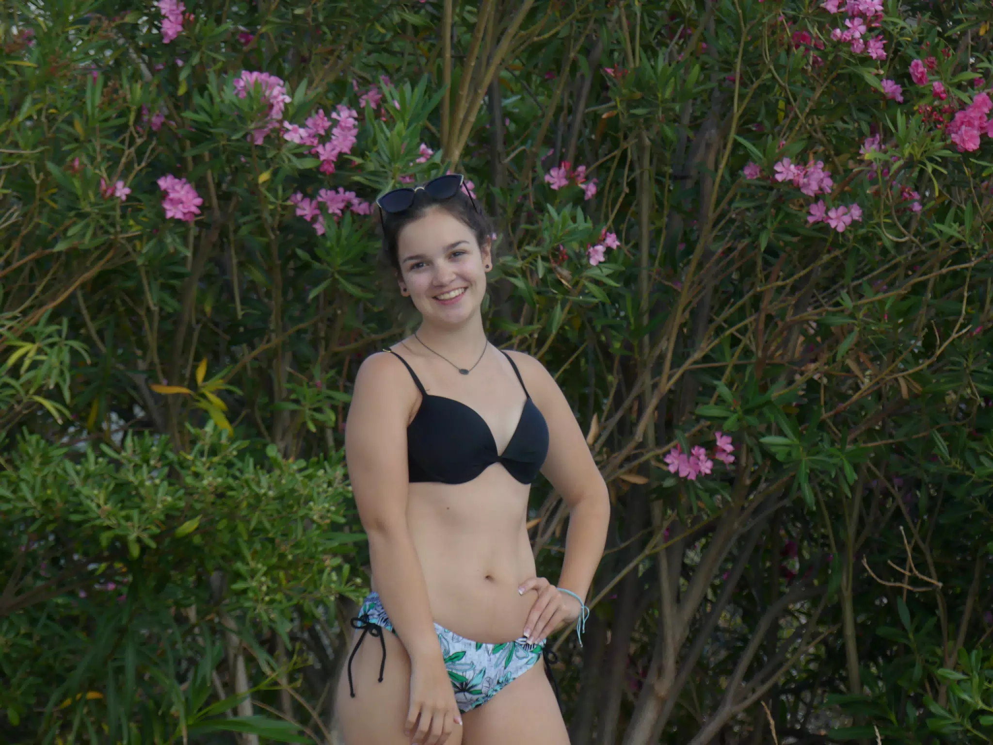 Teen Posing by Swimming Pool by Flowers in Aptera, Crete