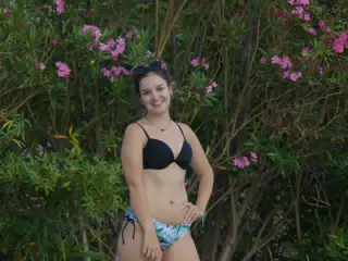 Teen Posing by Swimming Pool by Flowers in Aptera, Crete