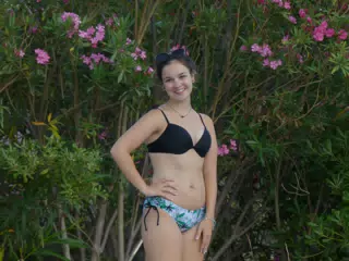 Emily in Swimsuit Posing by Flowers