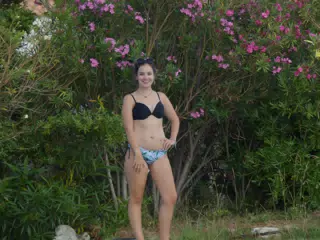 Emily Modeling by Pink Flowers Near Aptera Swimming Pool