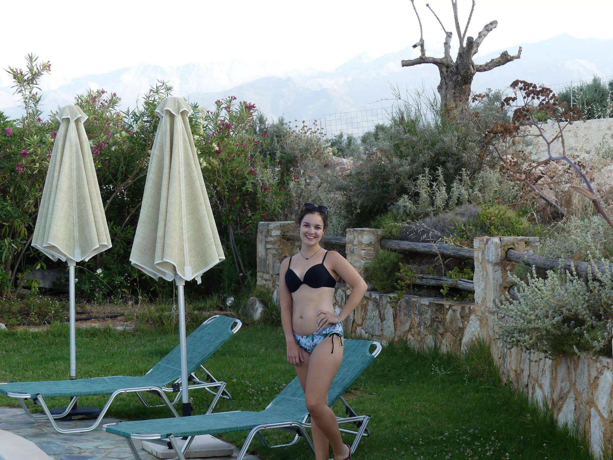Emily Posing by Swimming Pool at Aptera Apartment