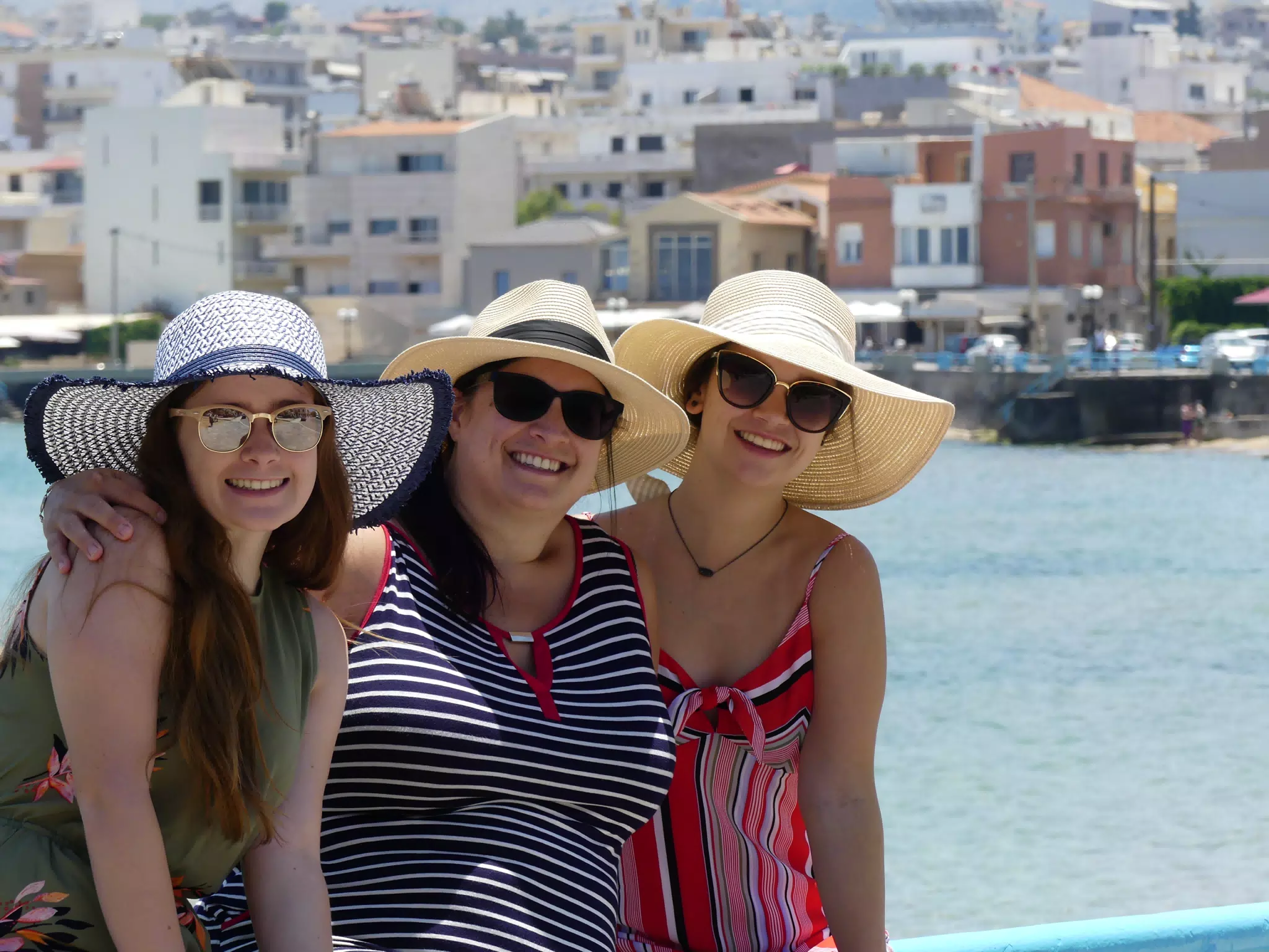 Madeine, Dominica & Emily in Chania by Waterfront Posing in Hats