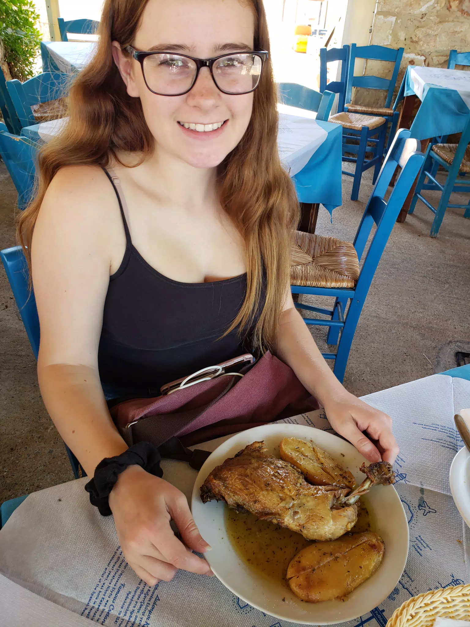 Madeline Grice with Grilled Chicken in Taverna in Aptera, Crete