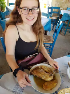 Madeline Grice with Grilled Chicken in Taverna in Aptera, Crete