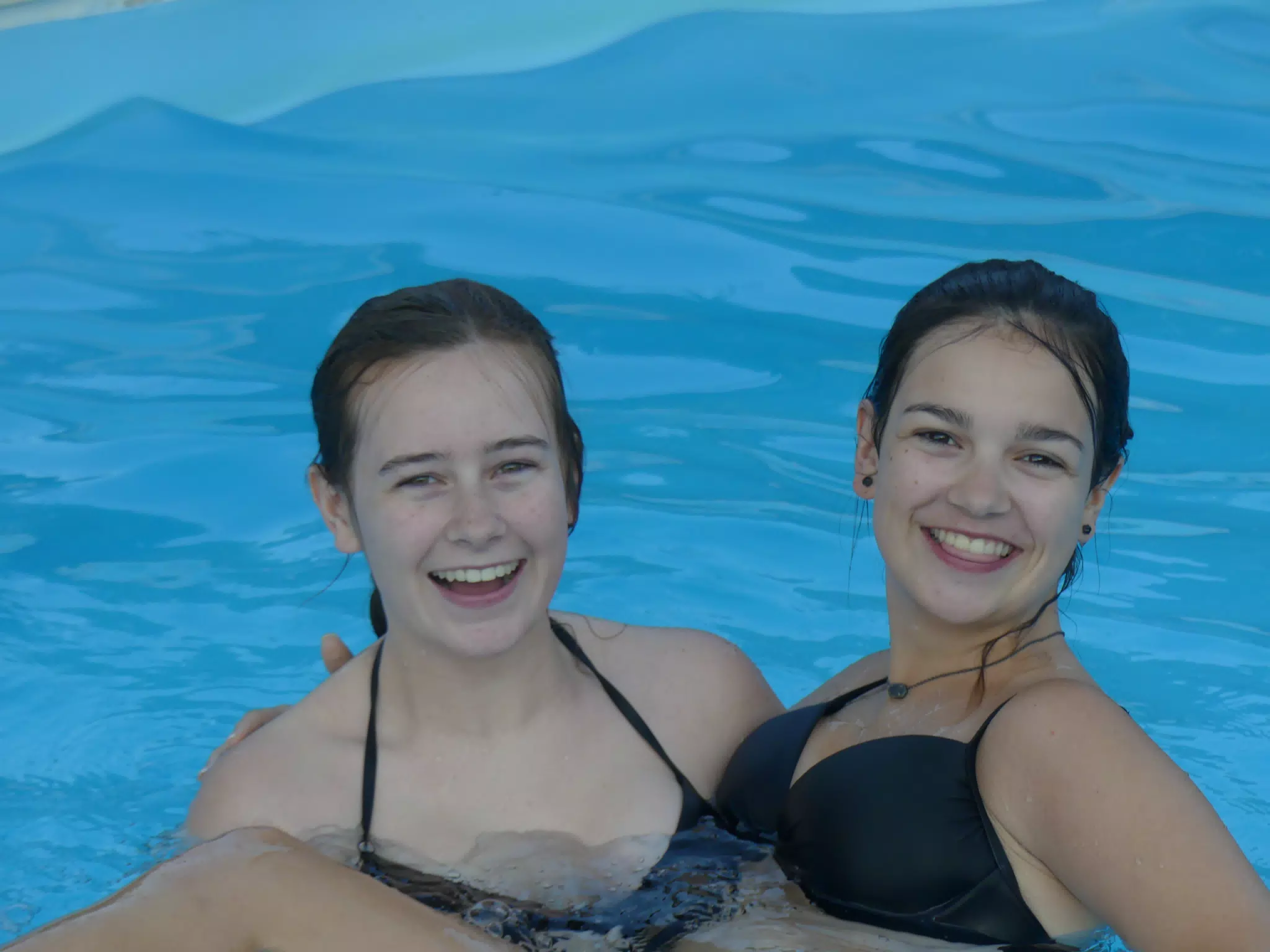 Madeline Holding Emily in Swimming Pool at Aptera Apartment