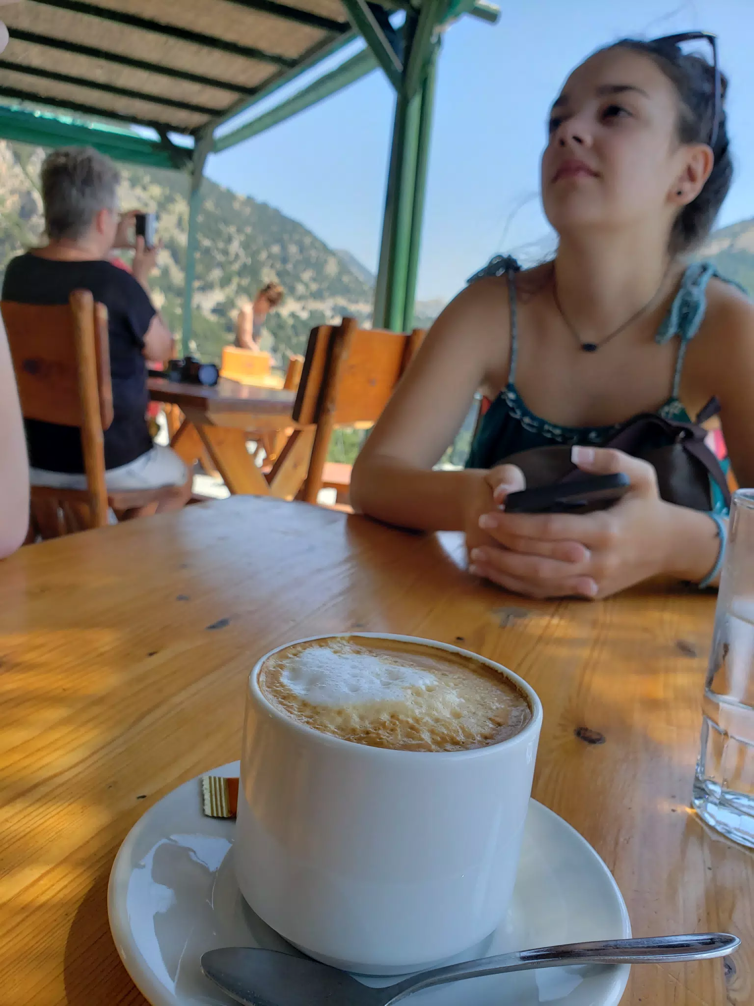 Emily in Background at Cafe