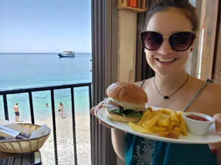Emily with Burger & Fries at Gyrogiali Grill House on Crete
