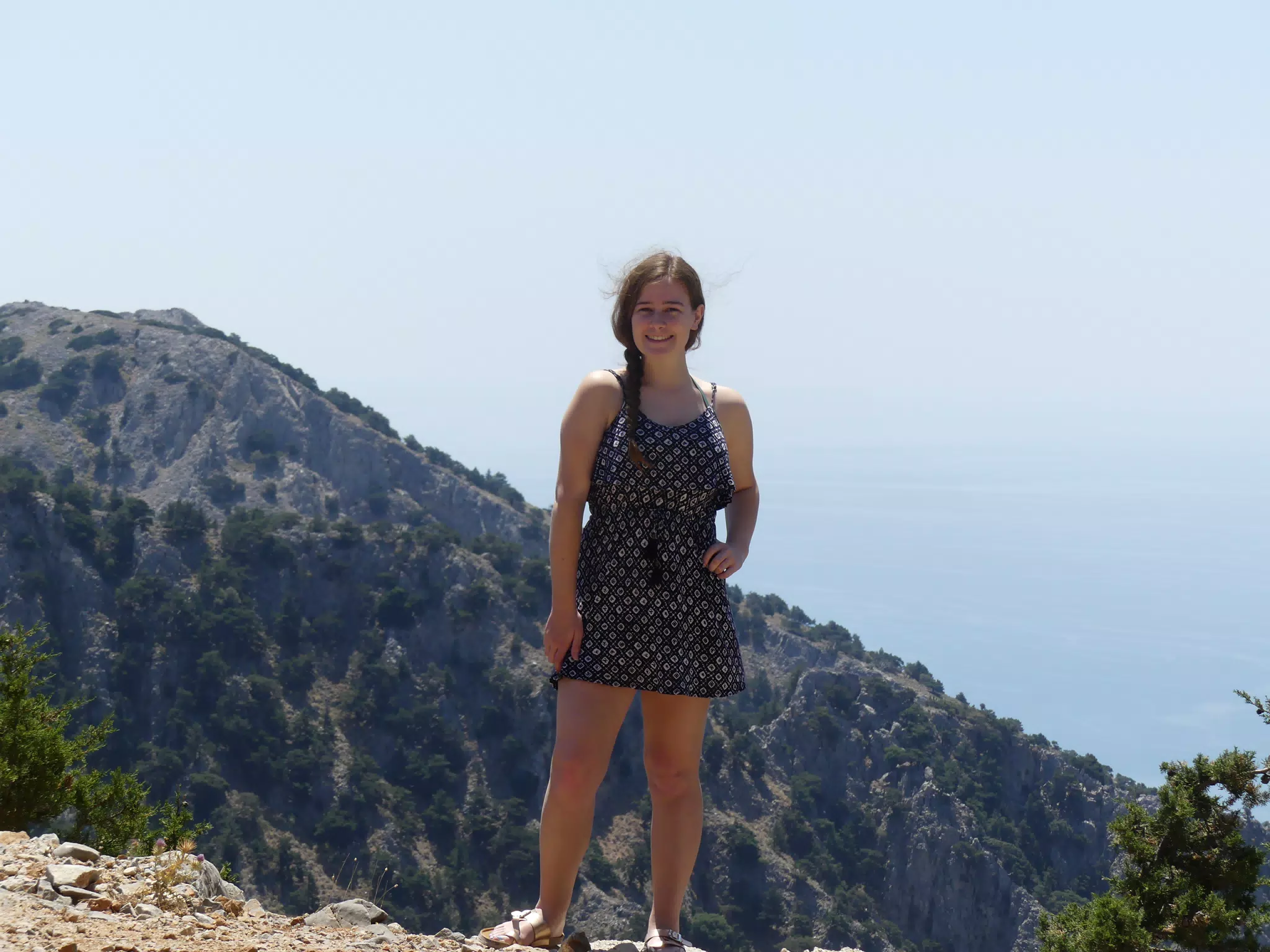 Madeline on Cliff Edge Above the Sea by Canyon on Crete