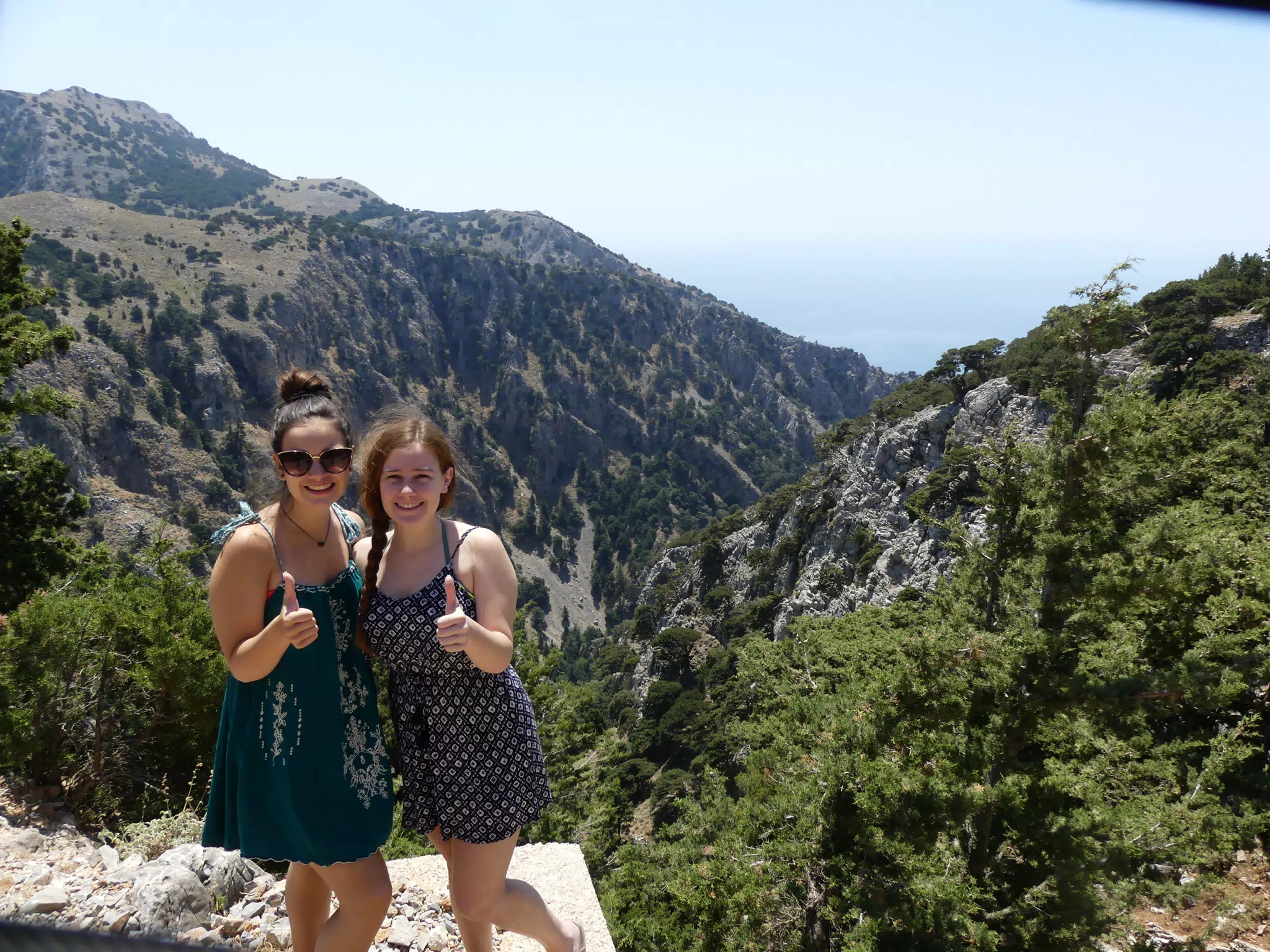 Teen Girls Thumbs Up Above Canyon in Greece
