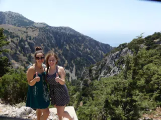 Teen Girls Thumbs Up Above Canyon in Greece