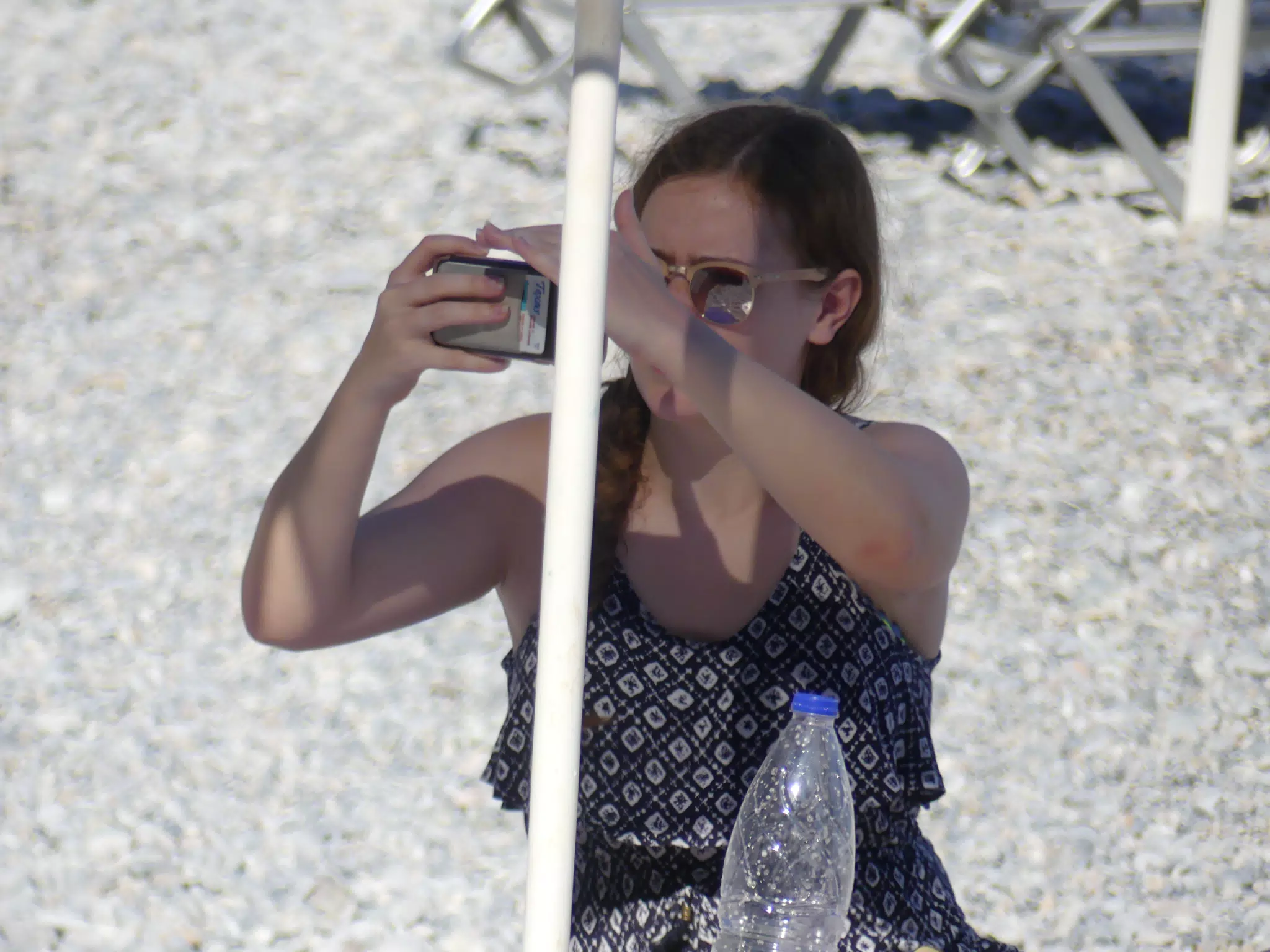 Madeline Using Phone in Bright Sunlight