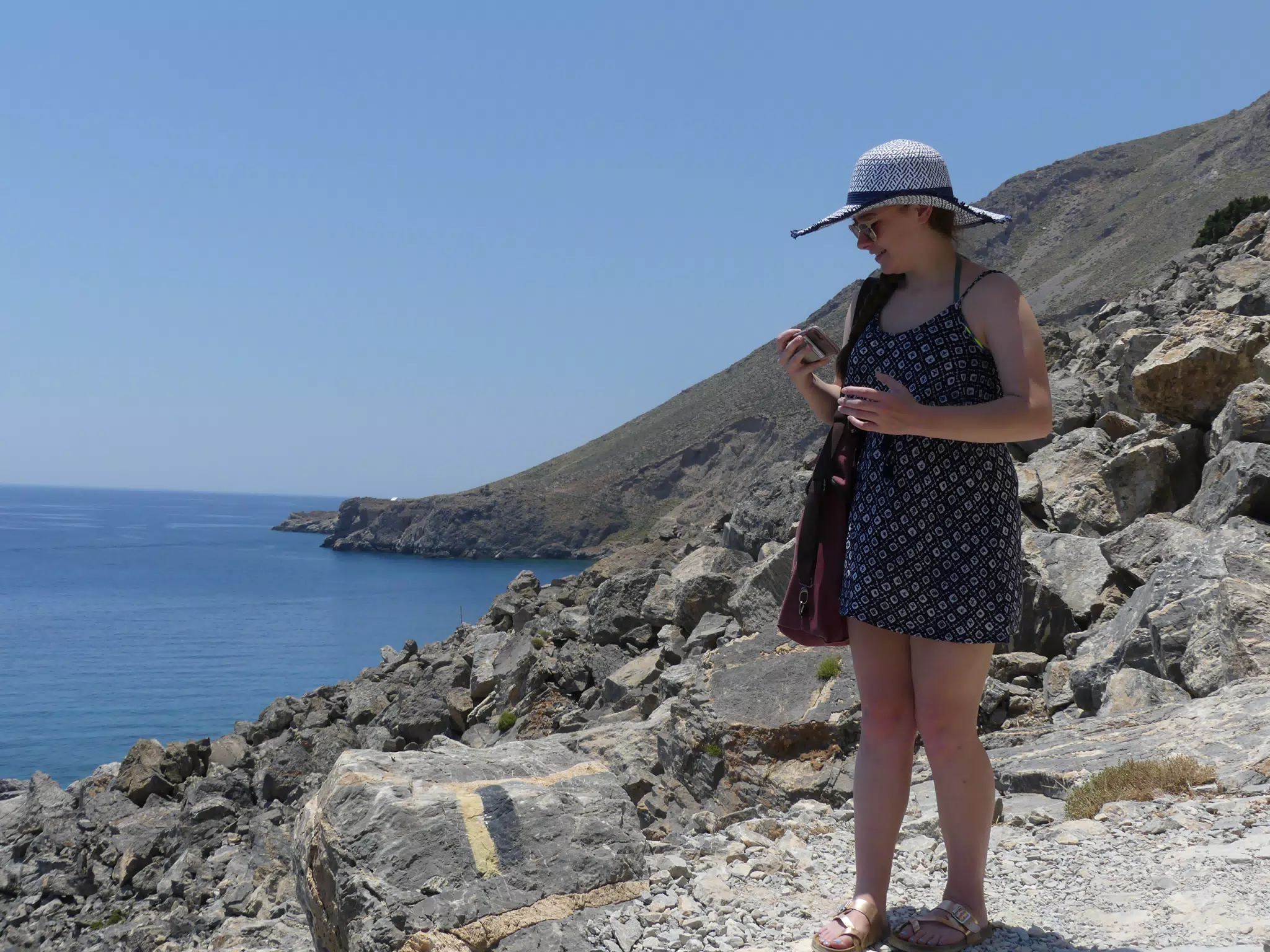 Madeline Checking Phone on Trail Hike on Crete