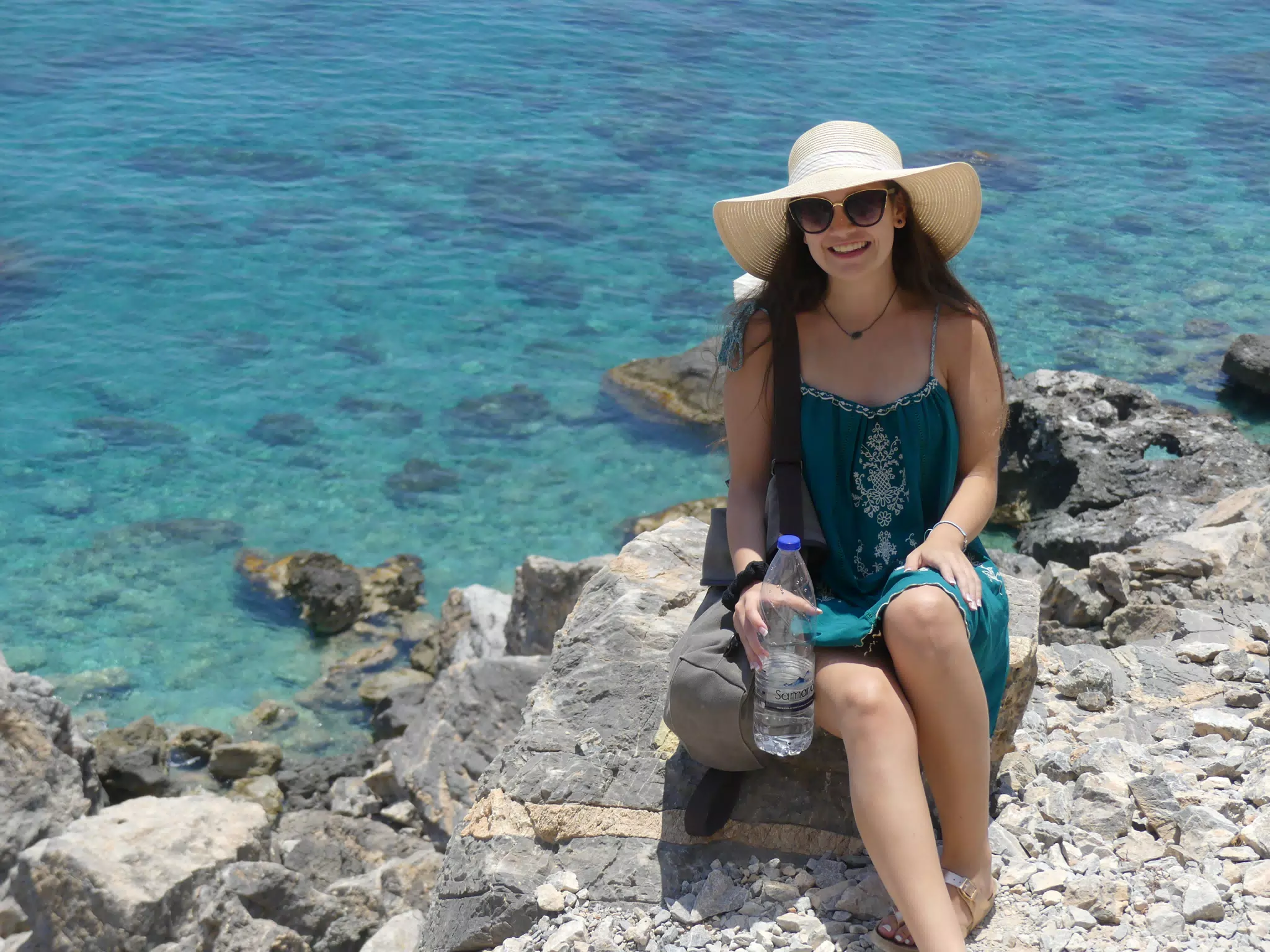 Emily in Dress, Hat & Sunglasses on Trail to Beach on Crete