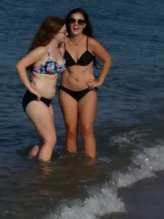 Girls in Swimsuits Laughting in Sea