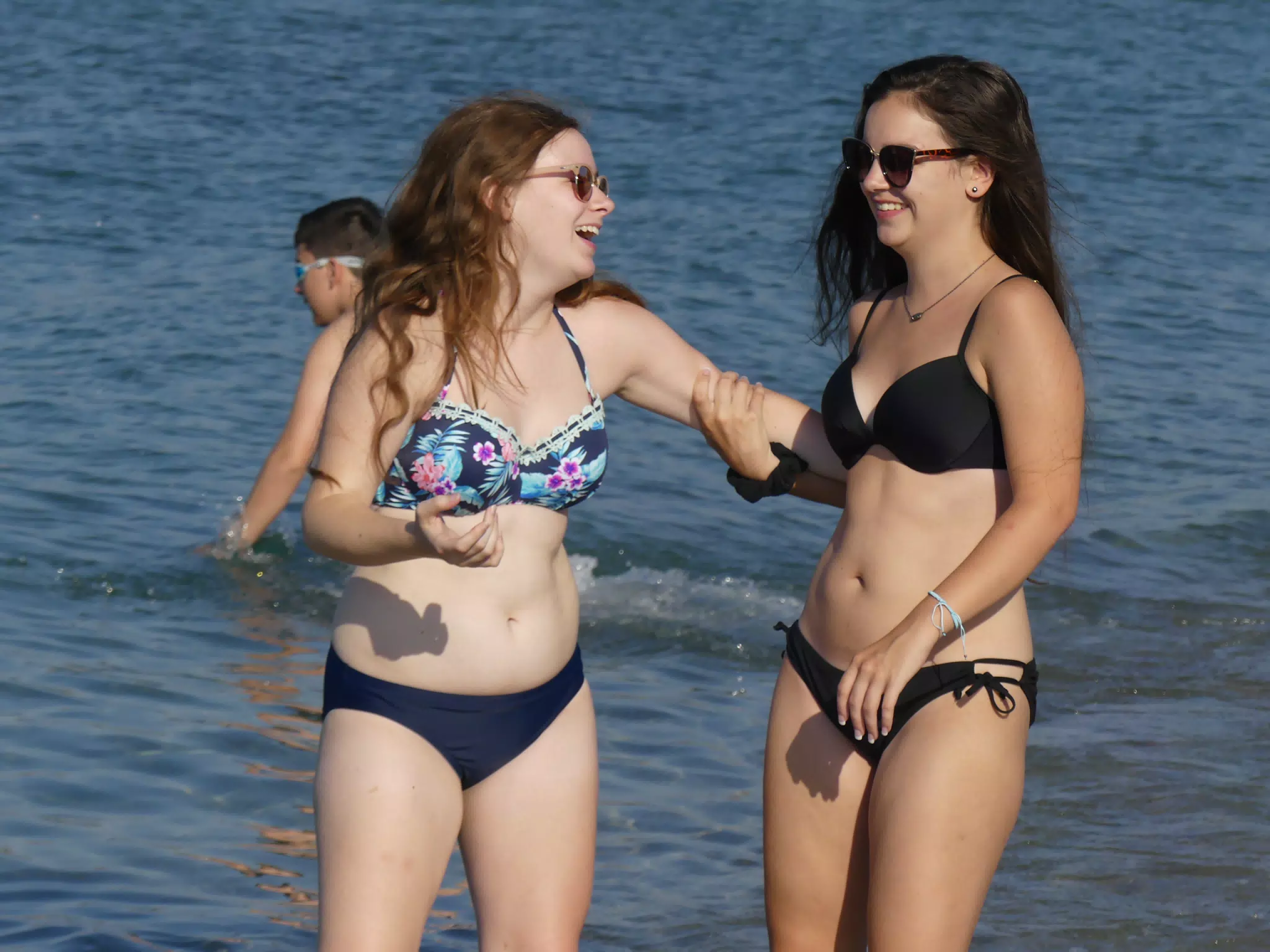 Teen Girls Laughing on Greek Beach in the Water